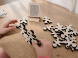 Owloo Master Buddies wooden balancing toy with a child building a balance structure using wooden figures