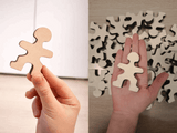 Owloo Master Buddies wooden balancing toy showing the size of a wooden figure held in a hand for scale