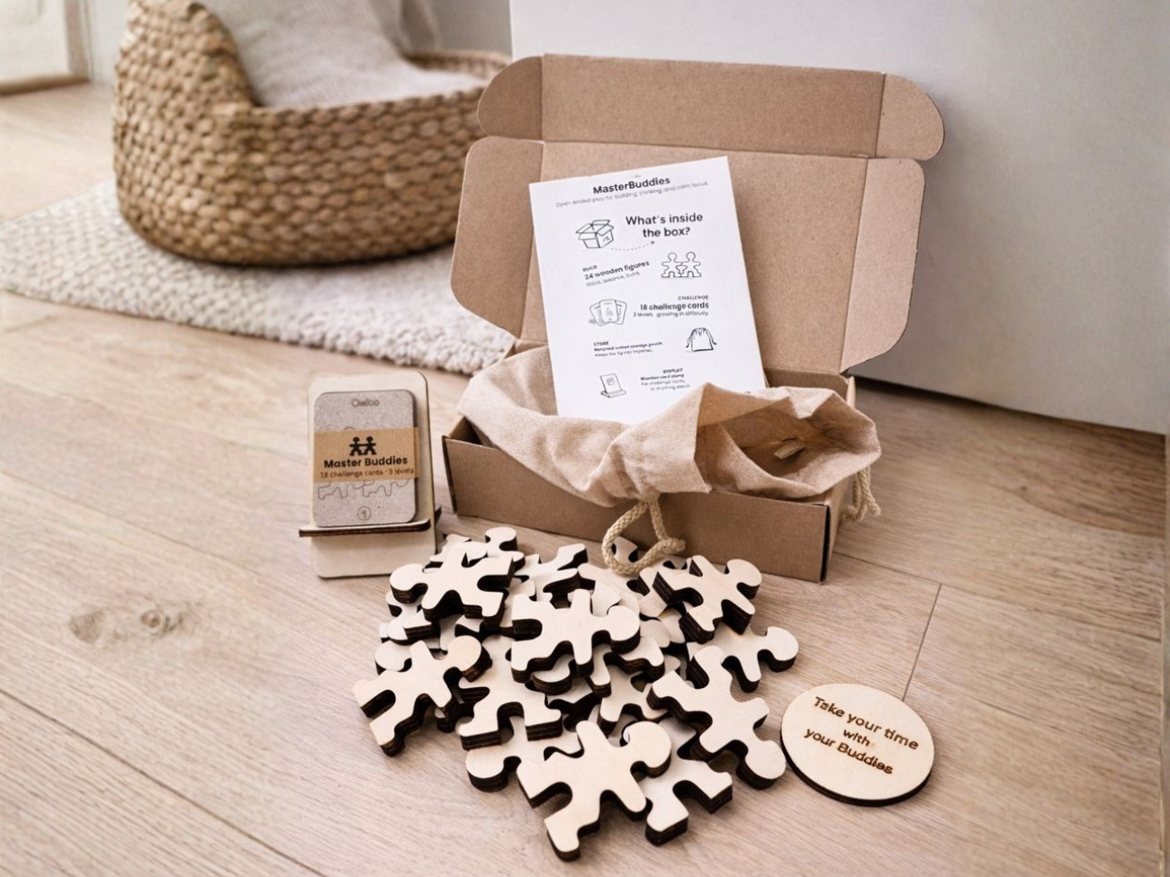 Owloo Master Buddies wooden toy set with challenge cards, storage bag and natural wooden figures displayed next to an open cardboard box