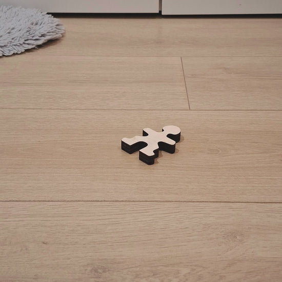 Owloo Master Buddies wooden balancing toy showing a single wooden figure on the floor in a minimal setup
