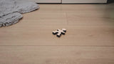 Owloo Master Buddies wooden balancing toy showing a single wooden figure on the floor in a minimal setup